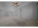 Neutral living room with tray ceilings, neutral carpet, and multiple entry points at 1828 Feliciana Ter, The Villages, FL 32162