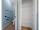 Bathroom storage and shelving in blue bathroom at 1828 Feliciana Ter, The Villages, FL 32162