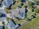 Aerial view of a luxurious home with a pool and landscaped yard at 1877 Quailey Ct, The Villages, FL 32163
