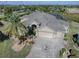 Luxury home with a large driveway and palm trees at 1877 Quailey Ct, The Villages, FL 32163