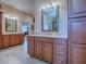 Double vanity bathroom with large mirror and upgraded cabinetry at 1877 Quailey Ct, The Villages, FL 32163