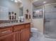 Bathroom with granite countertop and walk-in shower at 1877 Quailey Ct, The Villages, FL 32163