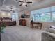 Spacious main bedroom with large window, seating area, and ample closet space at 1877 Quailey Ct, The Villages, FL 32163