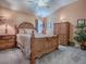 Cozy bedroom with a queen-size bed and wooden furniture at 1877 Quailey Ct, The Villages, FL 32163
