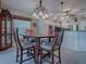 Kitchen dining area with wooden table and chairs, chandelier, and hardwood floors at 1877 Quailey Ct, The Villages, FL 32163