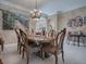 Elegant dining room featuring a large wooden table and charming wall art at 1877 Quailey Ct, The Villages, FL 32163