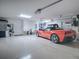 Garage with extra storage space and a red Corvette at 1877 Quailey Ct, The Villages, FL 32163