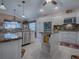 Island kitchen features granite countertops, stainless steel appliances, and white cabinets at 1877 Quailey Ct, The Villages, FL 32163