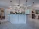 Modern kitchen with white cabinets, granite countertops, and stainless steel appliances at 1877 Quailey Ct, The Villages, FL 32163