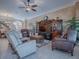 Comfortable living room with leather seating and a large TV at 1877 Quailey Ct, The Villages, FL 32163