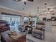 Spacious living area with a view of the kitchen and pool at 1877 Quailey Ct, The Villages, FL 32163