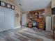 Home office with wood flooring, built-in shelving, and a comfortable workspace at 1877 Quailey Ct, The Villages, FL 32163