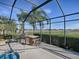 Outdoor kitchen with grill, mini-fridge and barstools at 1877 Quailey Ct, The Villages, FL 32163