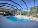 Screened pool and patio with built-in fountain and grill at 1877 Quailey Ct, The Villages, FL 32163