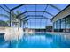 Refreshing pool with a water feature and screened enclosure at 1877 Quailey Ct, The Villages, FL 32163