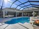 Spacious pool and patio with a view, fountain, and outdoor kitchen at 1877 Quailey Ct, The Villages, FL 32163
