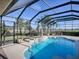 Relaxing pool and patio with a tranquil fountain and outdoor kitchen at 1877 Quailey Ct, The Villages, FL 32163