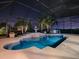 Night view of a refreshing pool and patio with a fountain at 1877 Quailey Ct, The Villages, FL 32163