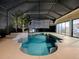 Night view of a relaxing pool and patio with a fountain at 1877 Quailey Ct, The Villages, FL 32163