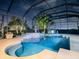 Relaxing pool and spa area with a fountain at night at 1877 Quailey Ct, The Villages, FL 32163
