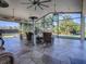 Relaxing screened patio with wicker furniture and a view of the backyard at 1877 Quailey Ct, The Villages, FL 32163