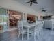 Sunroom with white table and chairs, view to the pool area at 1877 Quailey Ct, The Villages, FL 32163