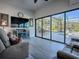 Sunroom with gray reclining sofas and sliding glass doors leading to the pool at 1877 Quailey Ct, The Villages, FL 32163