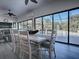 Sunroom with dining table and chairs, and view to the pool and garden at 1877 Quailey Ct, The Villages, FL 32163