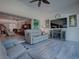 Relaxing sunroom with gray reclining sofas and a fireplace, view to the pool at 1877 Quailey Ct, The Villages, FL 32163