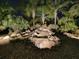 Night view of a waterfall feature with landscape lighting at 1877 Quailey Ct, The Villages, FL 32163