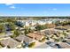 Neighborhood featuring single-Gathering homes, mature trees, and community buildings with beautifully landscaped grounds at 2169 Smoaks St, The Villages, FL 32162