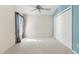 Inviting bedroom featuring neutral carpet, ample closet space, and natural light, creating a comfortable retreat at 2169 Smoaks St, The Villages, FL 32162
