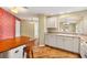 Bright kitchen featuring white cabinets, modern countertops, and a wooden bar at 2169 Smoaks St, The Villages, FL 32162