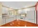 Bright kitchen with white cabinets and appliances, with an adjoining dining area at 2169 Smoaks St, The Villages, FL 32162