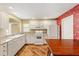 Bright kitchen with white cabinets and appliances, alongside a dining table at 2169 Smoaks St, The Villages, FL 32162