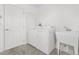 Functional laundry room equipped with white washer, dryer, a utility sink and ample lighting at 2169 Smoaks St, The Villages, FL 32162