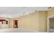 Expansive living room with neutral carpet, ceiling fan, and access to kitchen and other rooms, creating an open flow at 2169 Smoaks St, The Villages, FL 32162