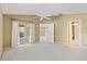 Spacious main bedroom with carpet, ceiling fan, access to bathroom and doors to other rooms at 2169 Smoaks St, The Villages, FL 32162