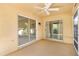Covered patio with ceiling fan and sliding glass doors, perfect for outdoor entertaining or relaxing at 2169 Smoaks St, The Villages, FL 32162