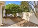 Charming side yard featuring mature trees, lush landscaping, and a private outdoor space at 2169 Smoaks St, The Villages, FL 32162