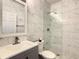 Modern bathroom with marble tile, walk-in shower, and updated vanity at 223 Knollwood Dr, Davenport, FL 33837