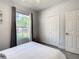 Bedroom with large window, double doors to closet, and neutral decor at 223 Knollwood Dr, Davenport, FL 33837