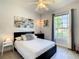 Bright bedroom with large window, ceiling fan, and ample closet space at 223 Knollwood Dr, Davenport, FL 33837