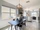 Kitchen dining area with farmhouse table and gray cabinets at 223 Knollwood Dr, Davenport, FL 33837