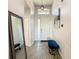 Welcoming entryway, featuring a blue bench and a large mirror at 223 Knollwood Dr, Davenport, FL 33837