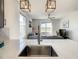 Modern kitchen sink with a view into living room at 223 Knollwood Dr, Davenport, FL 33837