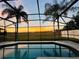 Sunset view from screened pool and lanai at 223 Knollwood Dr, Davenport, FL 33837