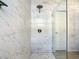 Large walk-in shower with marble tile and glass door at 223 Knollwood Dr, Davenport, FL 33837