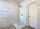 Spacious walk-in shower with marble tile at 223 Knollwood Dr, Davenport, FL 33837