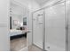 Bathroom featuring a shower with glass doors and white tile at 2676 Spider Lily Ct, Clermont, FL 34711